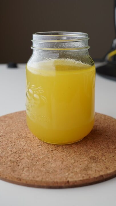 clear glass jar with yellow liquid inside